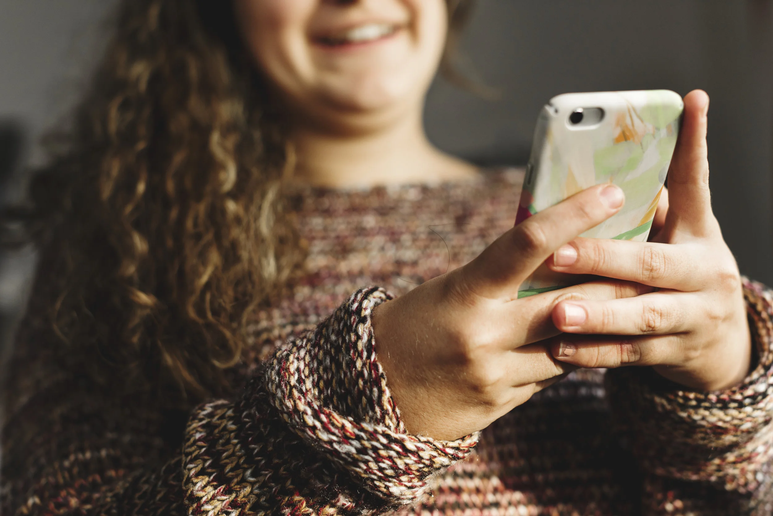 Teenage girl using a smartphone on a bed social media and addiction concept