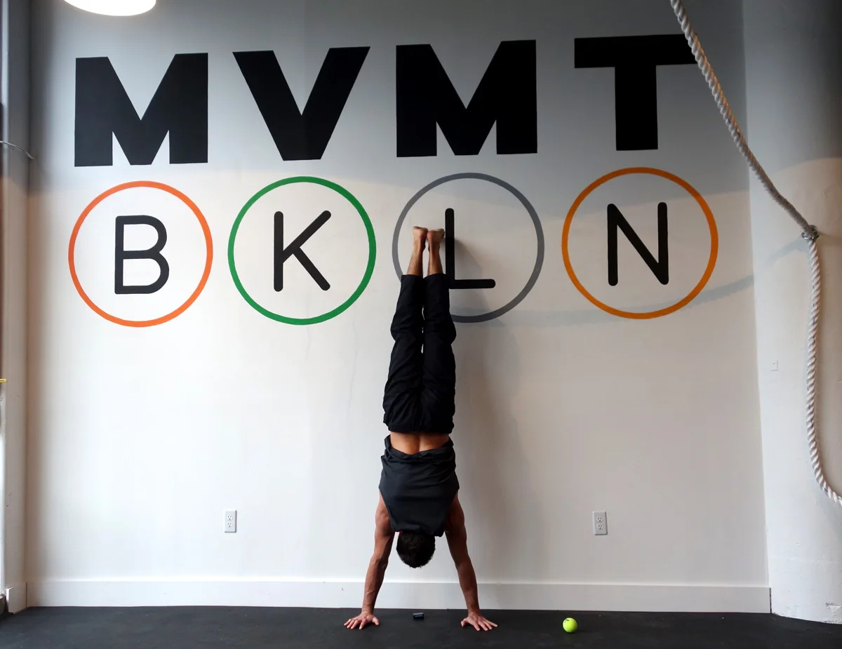 Hand painted logo on interior handstand wall for Movement Brooklyn .