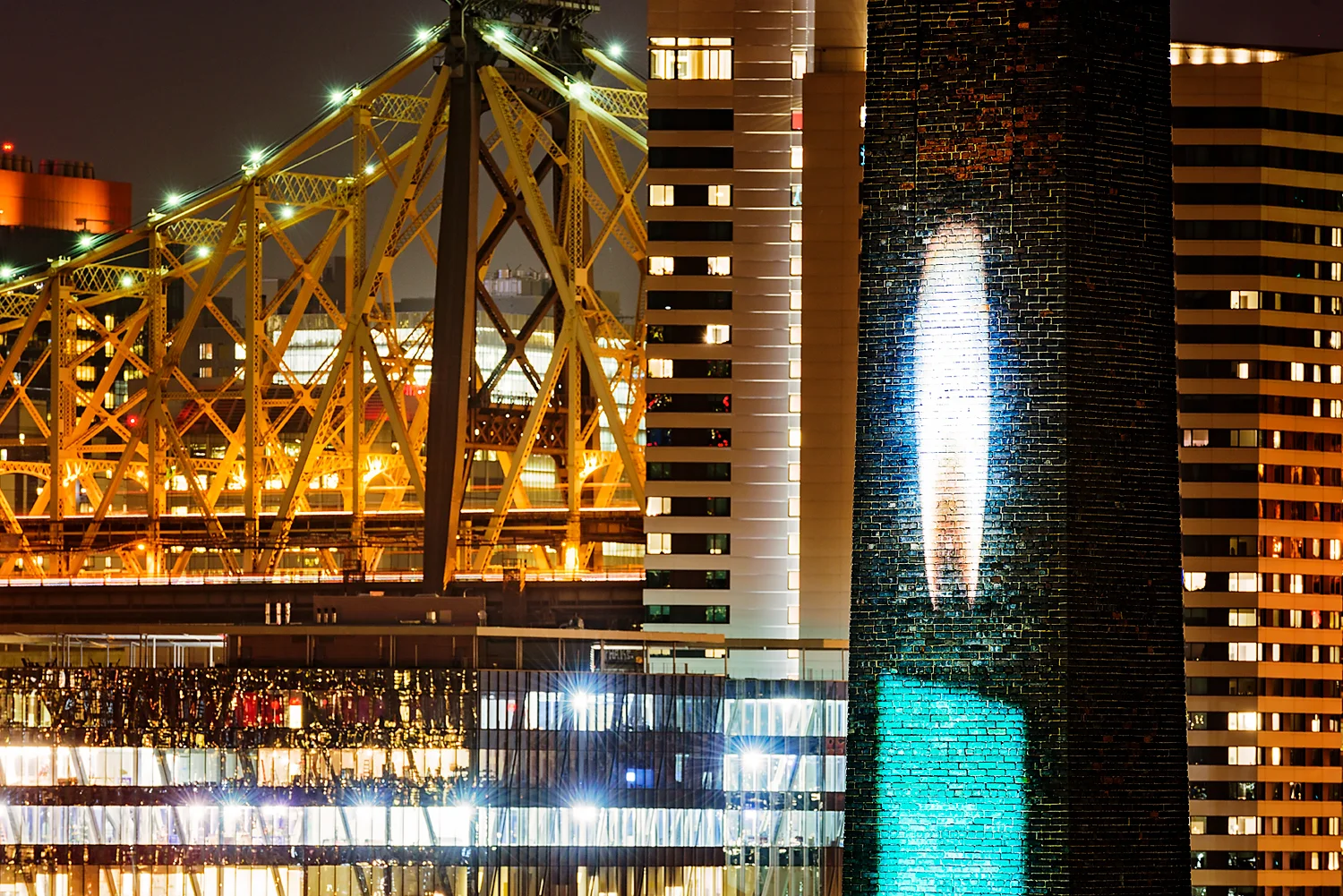 Candela is projected on a 50' brick smokestack. Photo by www.8thRulePhoto.com