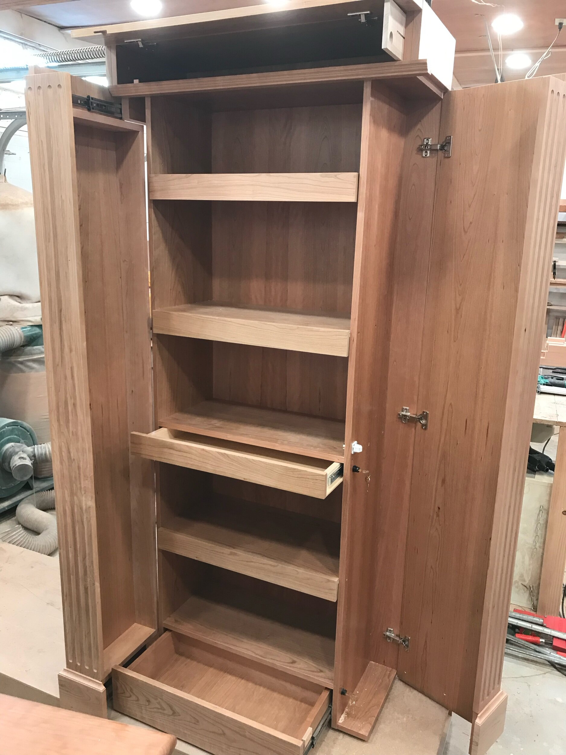 QLine SafeGuard hidden compartment bookcase with shelves open to reveal concealed storage compartments.