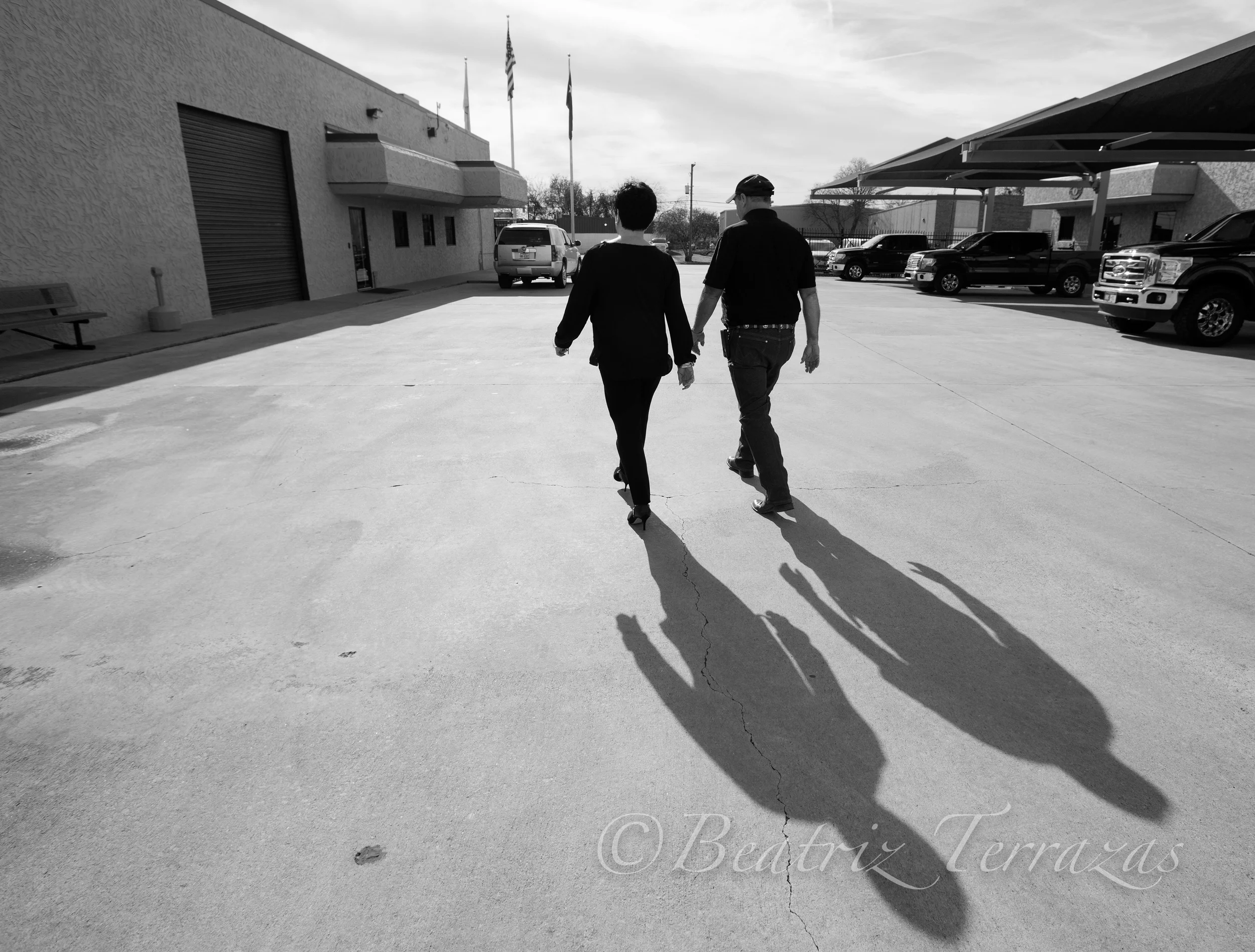 Sandra walking on the campus of her roofing and disposal company with one of her managers.