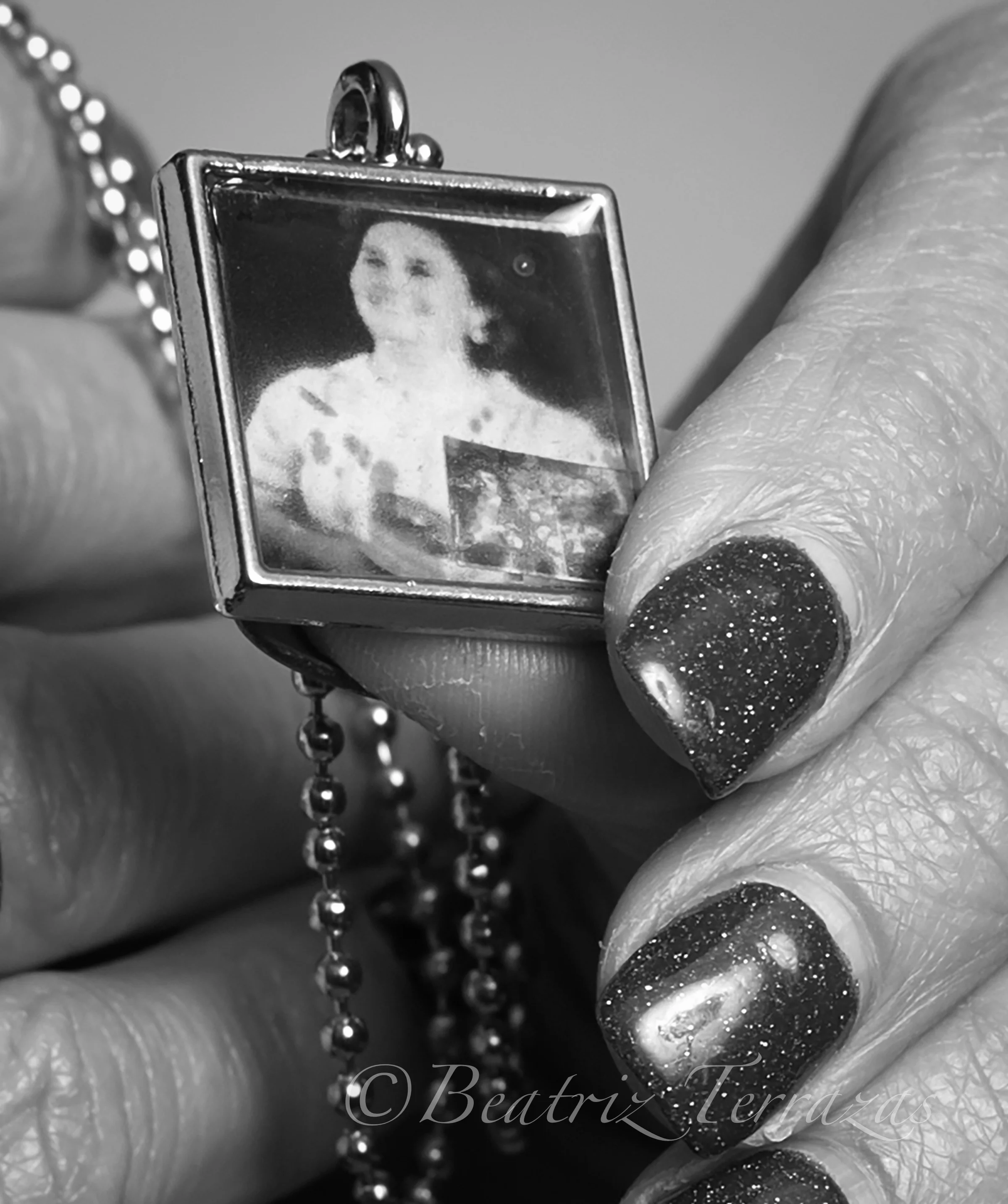 Susie sometimes wears a pendant with her mother's photo on it. I attended a concert in which Susie's son performed with his high school band, and Susie wore the locket as a way to honor her mother's own music, as well as to have her present at the performance.