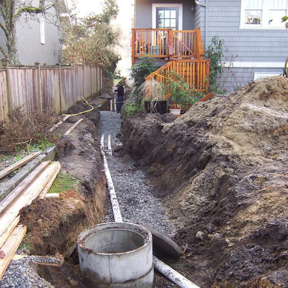 Separate sanitary and storm water sewer pipes connecting a laneway house to the city services in the front yard.
