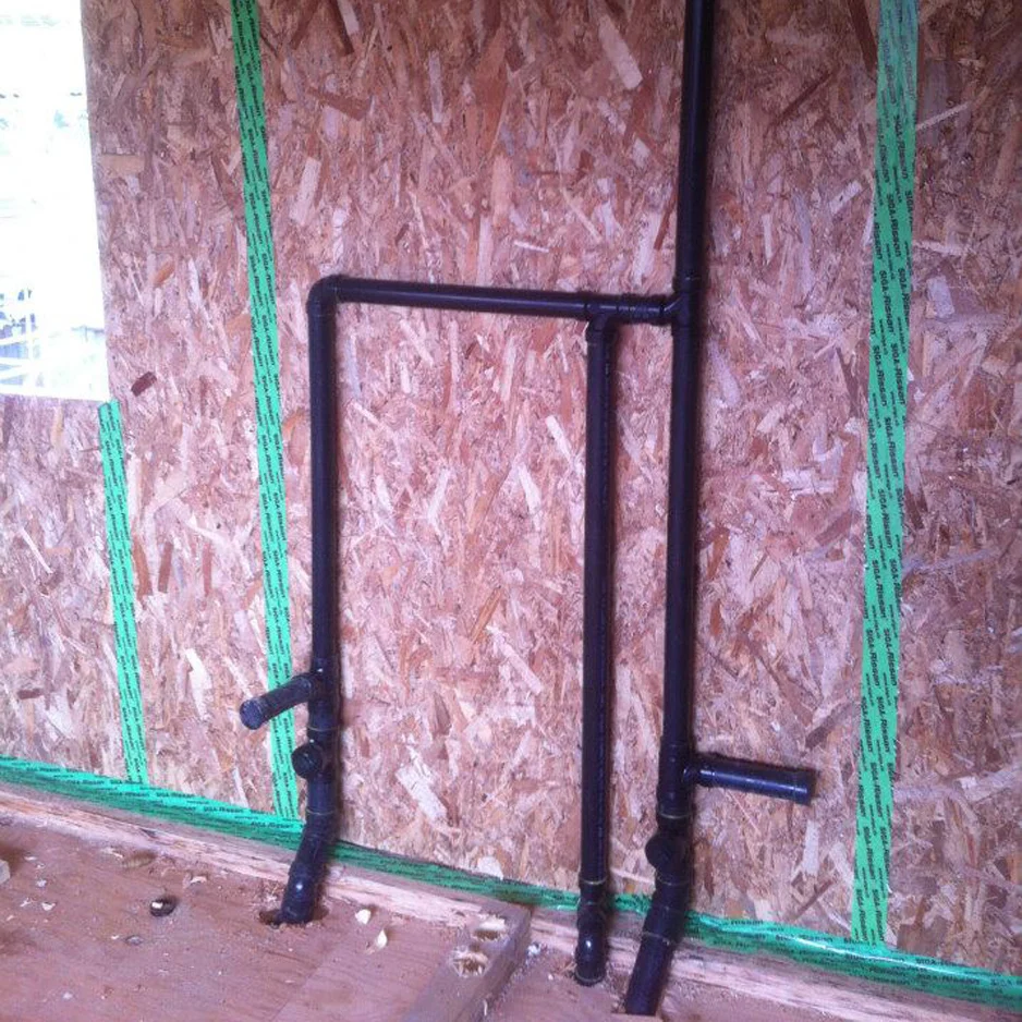 Drainage pipes for a bathroom. The inner 'service wall' will be framed around these pipes.