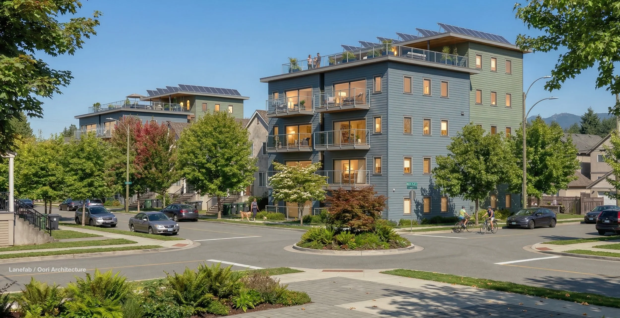 Modern single stair multi-story apartment buildings with solar panels on the roofs, surrounded by green trees and a parking lot with cars. People are riding bikes, walking a dog, and the sky is clear.