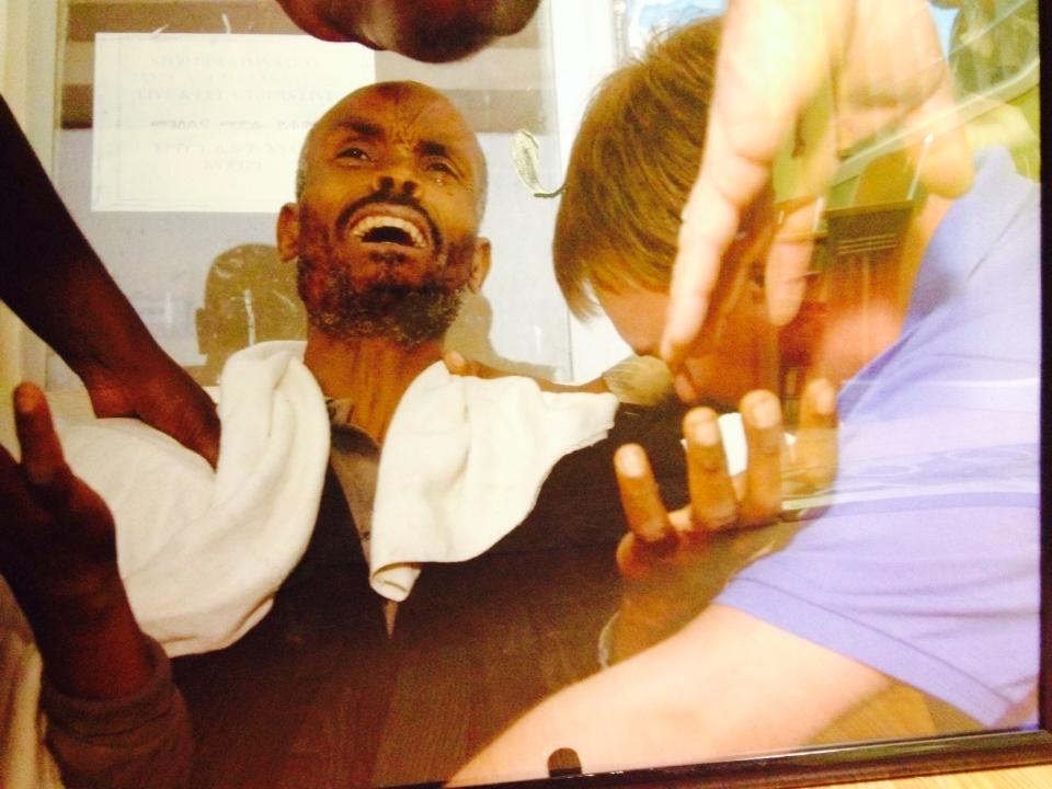 Actual photo of paralyzed man receiving prayer.
