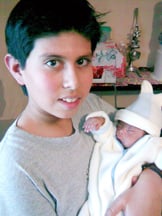 Estaban with raised baby