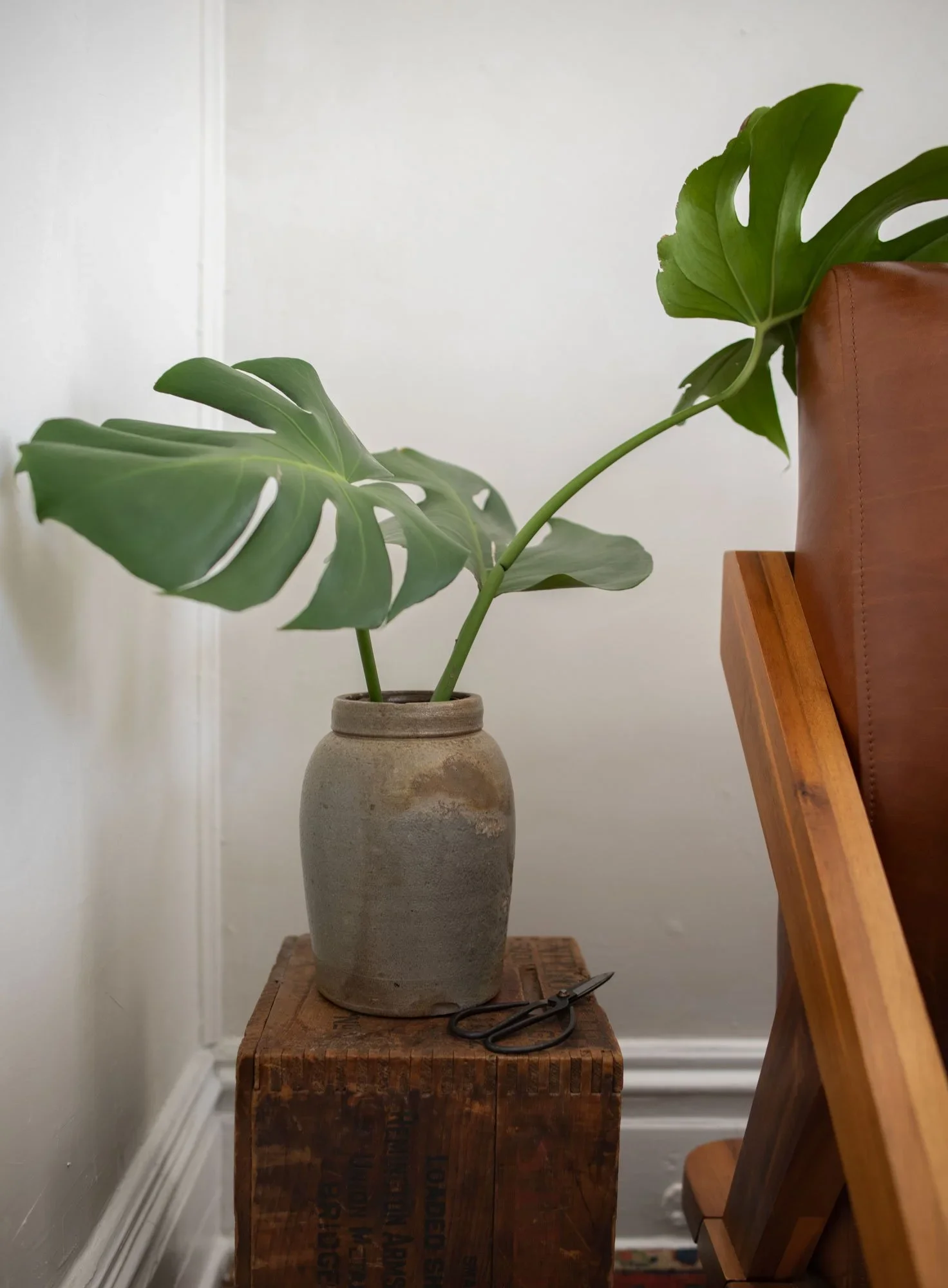 bedroom with antique pottery and fresh cut greenery