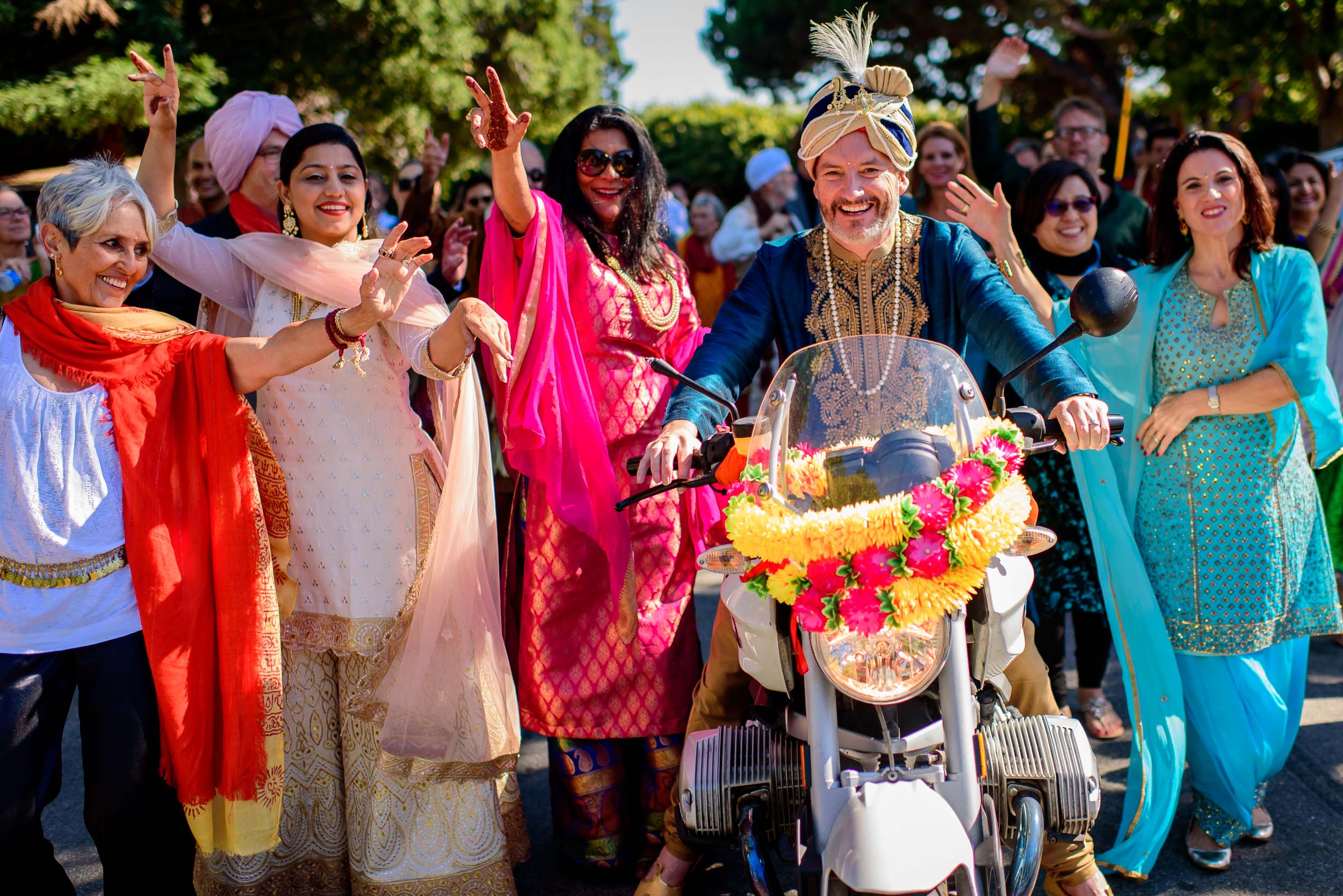 Groom riding a bike for his baraat