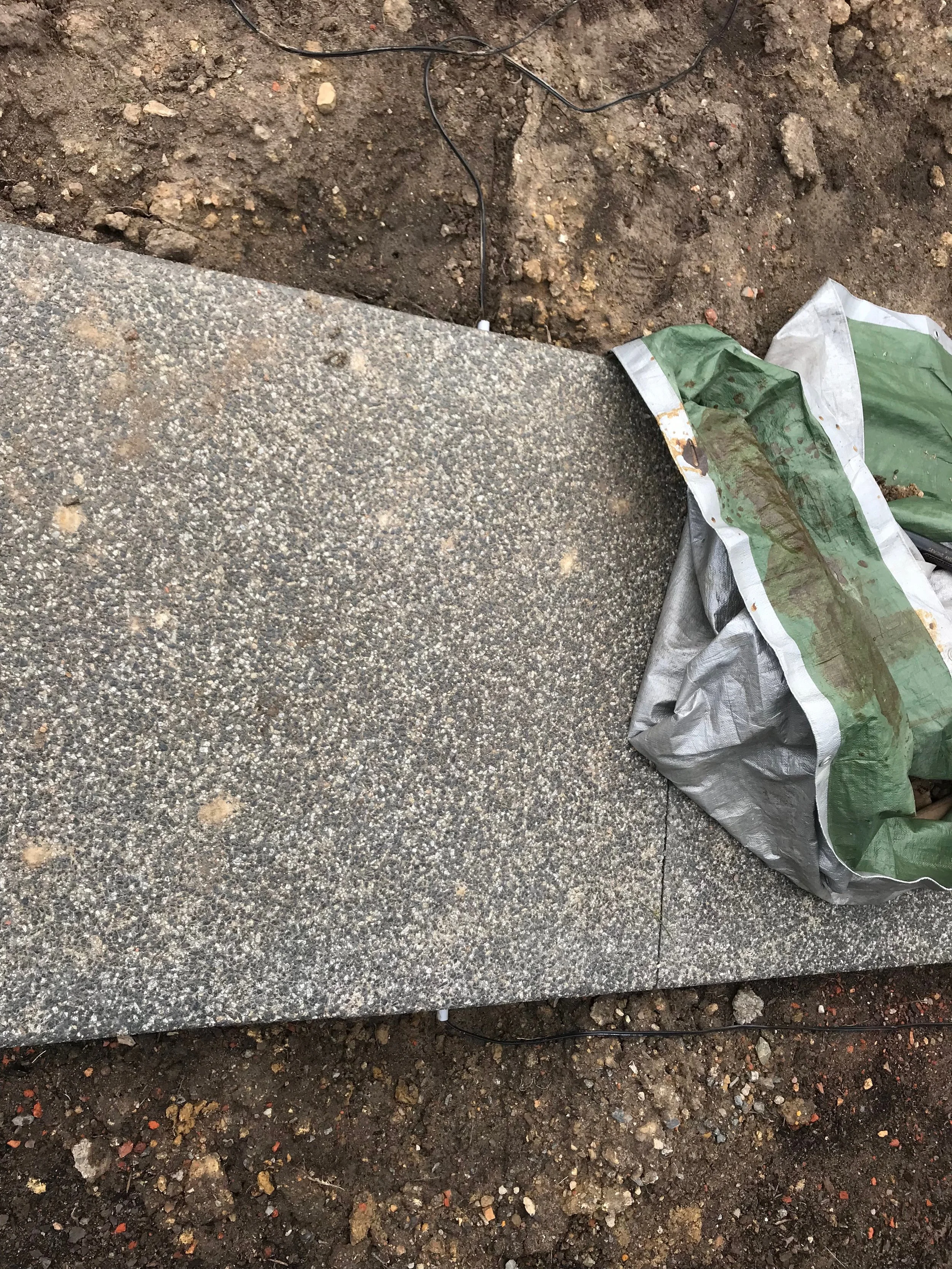 Conduit beneath the concrete walkway to feed the cable to the front of the garden.
