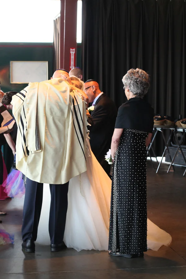 Deetza hugs her brother before the ceremony starts as her mother looks on. 