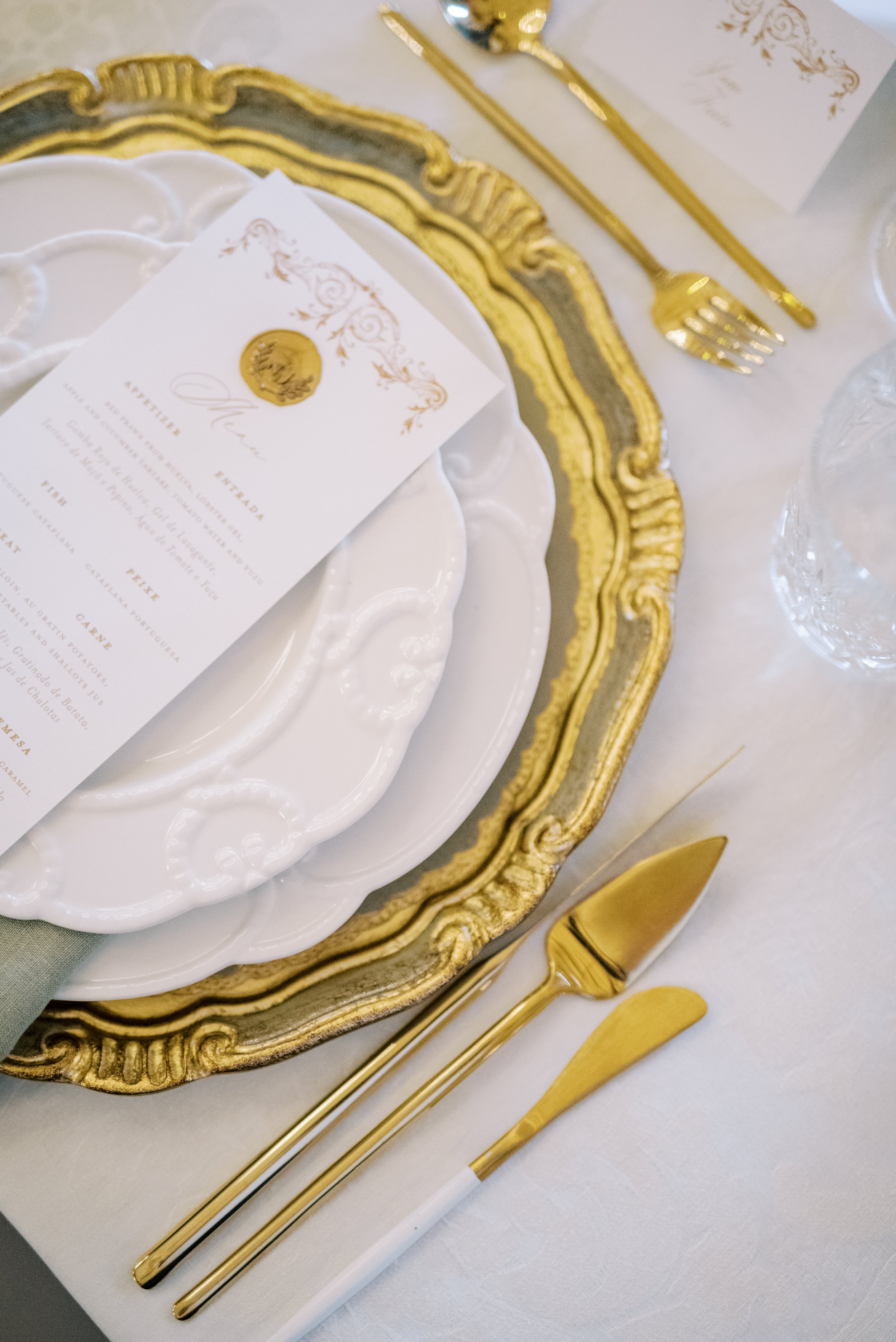 Luxury white and gold wedding plate set with the menu on top 