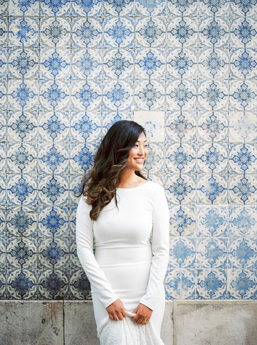 Beautiful bride at her engagement shoot standing in front of blue and white tiles