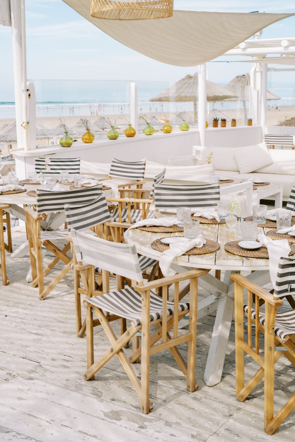 Table set for a wedding brunch next to the sea,  with a touch of Bohemia style and breeze in the air