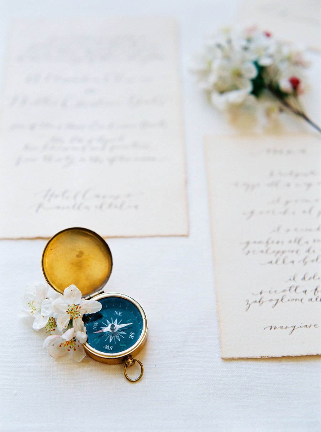 Flat lay with wedding stationary and a compass