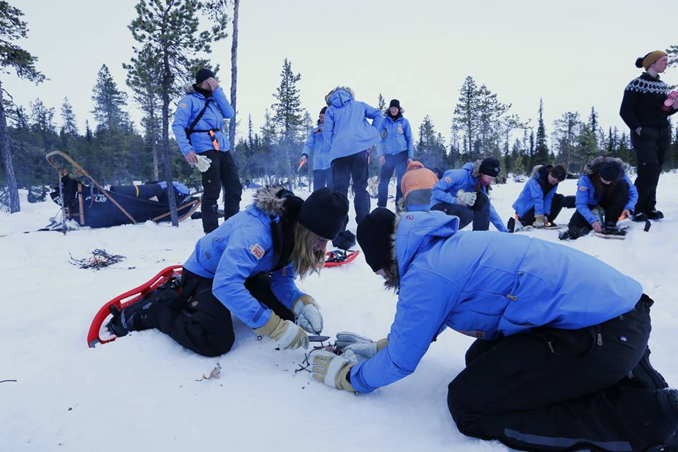 My Swedish teammate, Hana Chatila, creates a wind block while I try (in vain) to ignite birch bark with a knife and fire steel. (Photo by Jun-Hee Cho. All rights reserved.)
