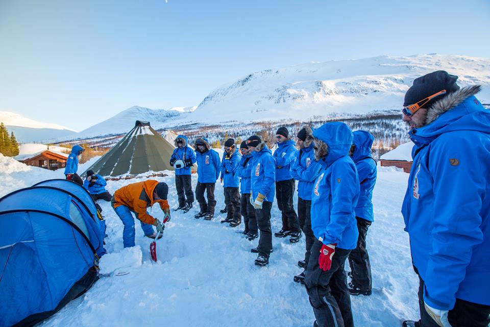 In the relatively protected environment of the Tamok Valley, Fjällraven outdoor expert Johan Skullman instructs Polar participants on the mechanics of pitching a tent in winter conditions. (Photo by Peter Holly. All rights reserved.)
