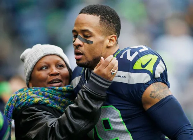 Earl Thomas III loving his mom on the field.jpg