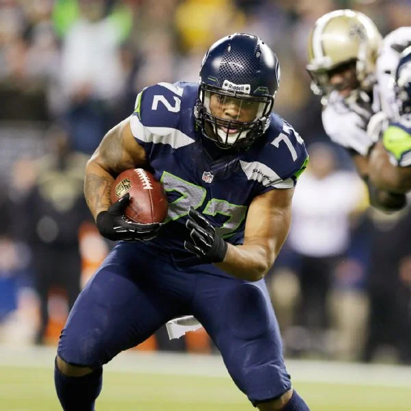 Michael Bennett looking hot with the football in his arms like a newborn child.jpg