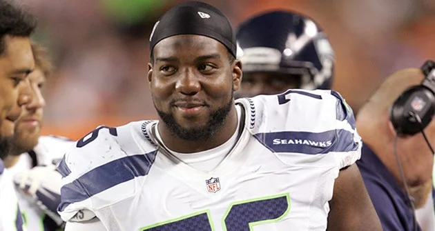 Russell Okung smirking bc he knows he's hot.jpg