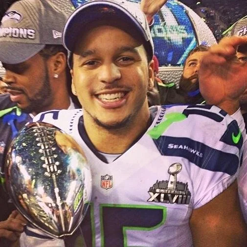 Jermaine Kearse smiling and looking hot with the super bowl trophy.jpg