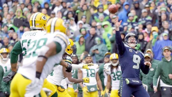 Jon Ryan throwing the ball to Garry Gilliam to complete a touchdown.jpg