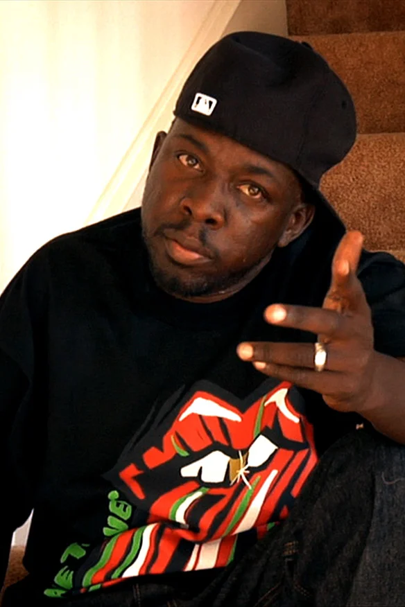 Phife Dawg looking hot on the stairs.jpg