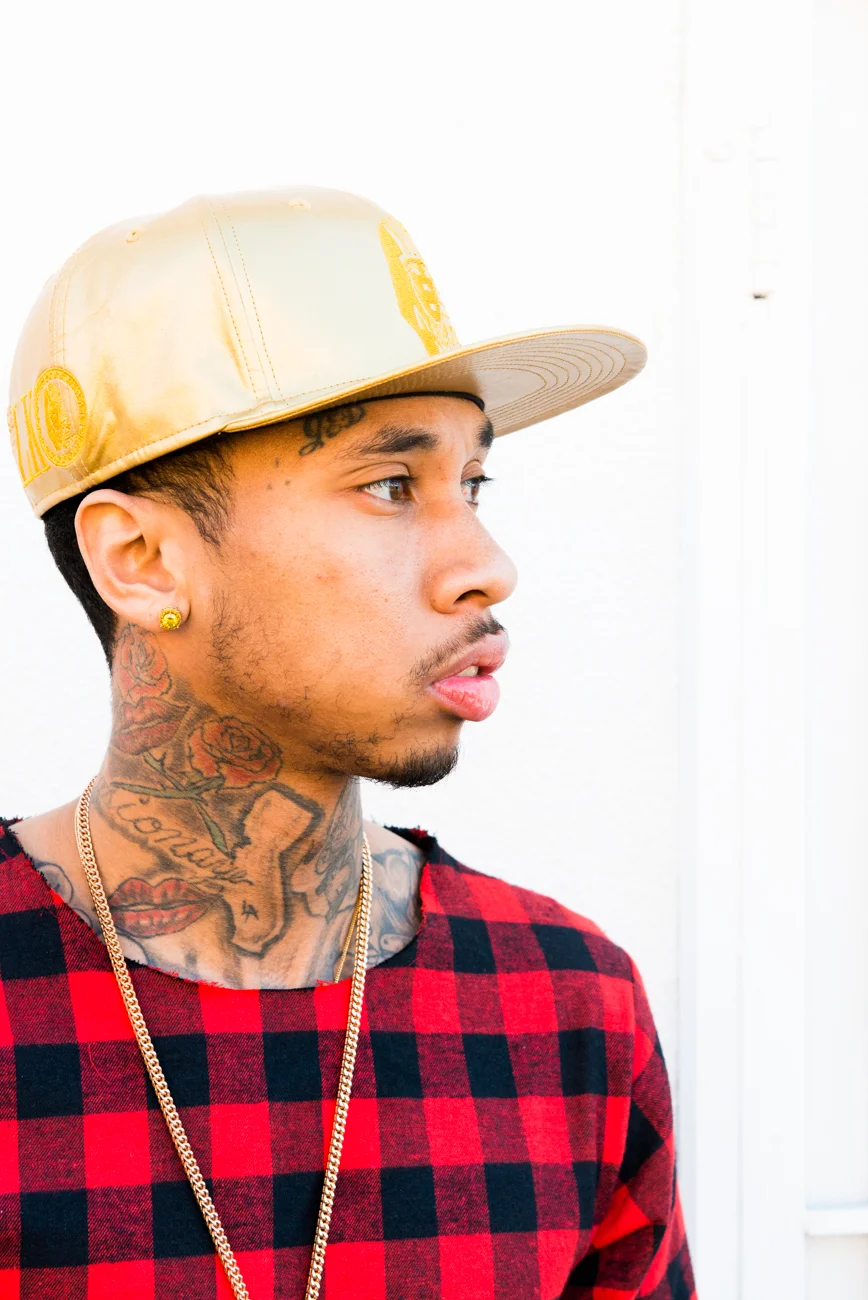 Tyga looking gorgeous in flannel and a gold hat.jpg