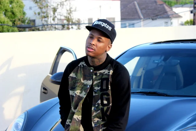 YG sitting on the hood of a car.jpg