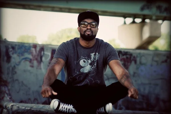 Hezekiah sitting indian style underneath the bridge.jpg