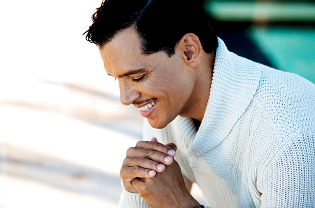 El DeBarge in recent years looking down with his hot smile pouring out into the scene with a nice knit sweater on.jpg