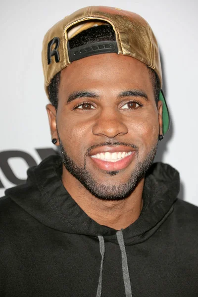 Jason Derulo wearing a black sweatshirt and a gold hat looking gorgeous as usual.jpg