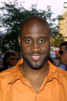Plug 1 aka Posdnuos looking hot in an orange polo shirt.jpg