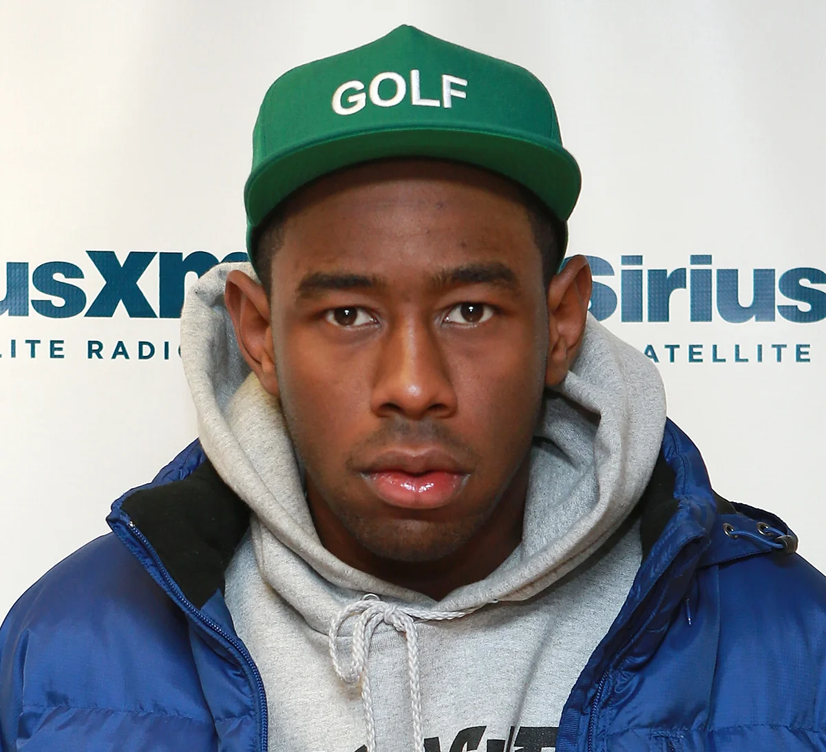 Tyler The Creator wearing a hooded sweatshirt and a jacket together bc he must be cold.jpg