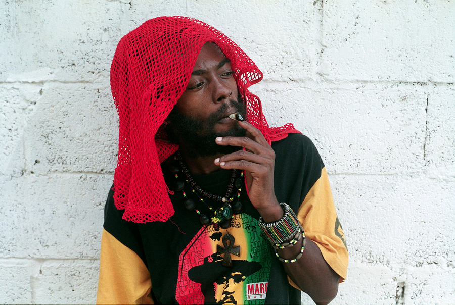 I Wayne smoking and looking hot up against a painted white cinderblock brick wall.jpg