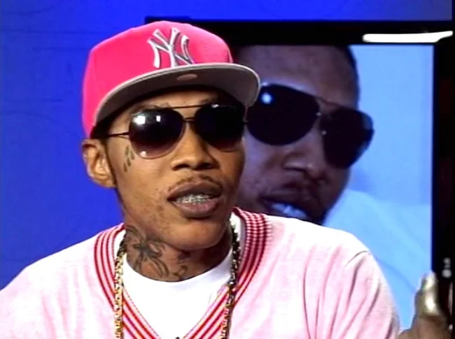 Vybz Kartel looking hot and incognito with sunglasses on and a red yankee fitted hat.jpg