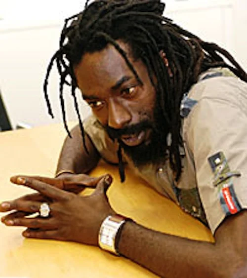 Buju Banton looking hot sitting at a desk.jpg