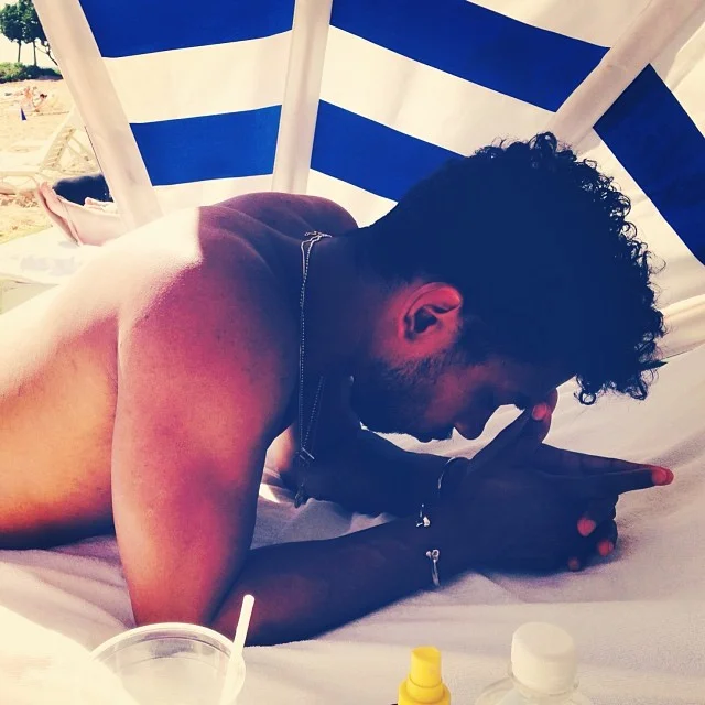 Miguel looking so hot under an umbrella at the beach with no shirt on omg.jpg