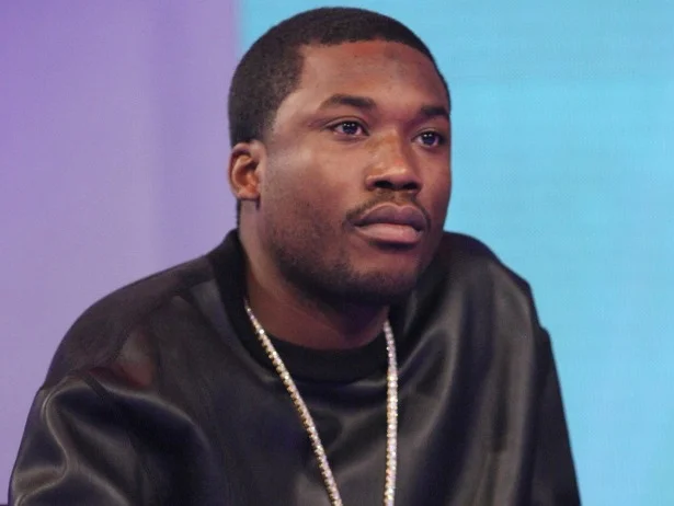 Meek Mill looking hot and serious in front of a two tone background.jpg