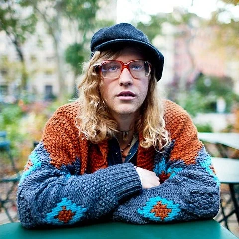 Allen Stone outside thinking while wearing a sweater and looking hot.jpg