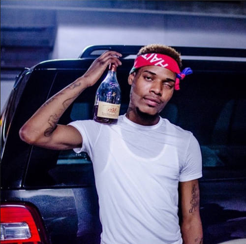 Fetty Wap looking hot in a wife beater and a t-shirt with a bandana on and a 40.jpg