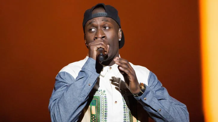 Vincent Dery wearing a hat and looking hot in a nice shirt as he talks into the microphone.jpg