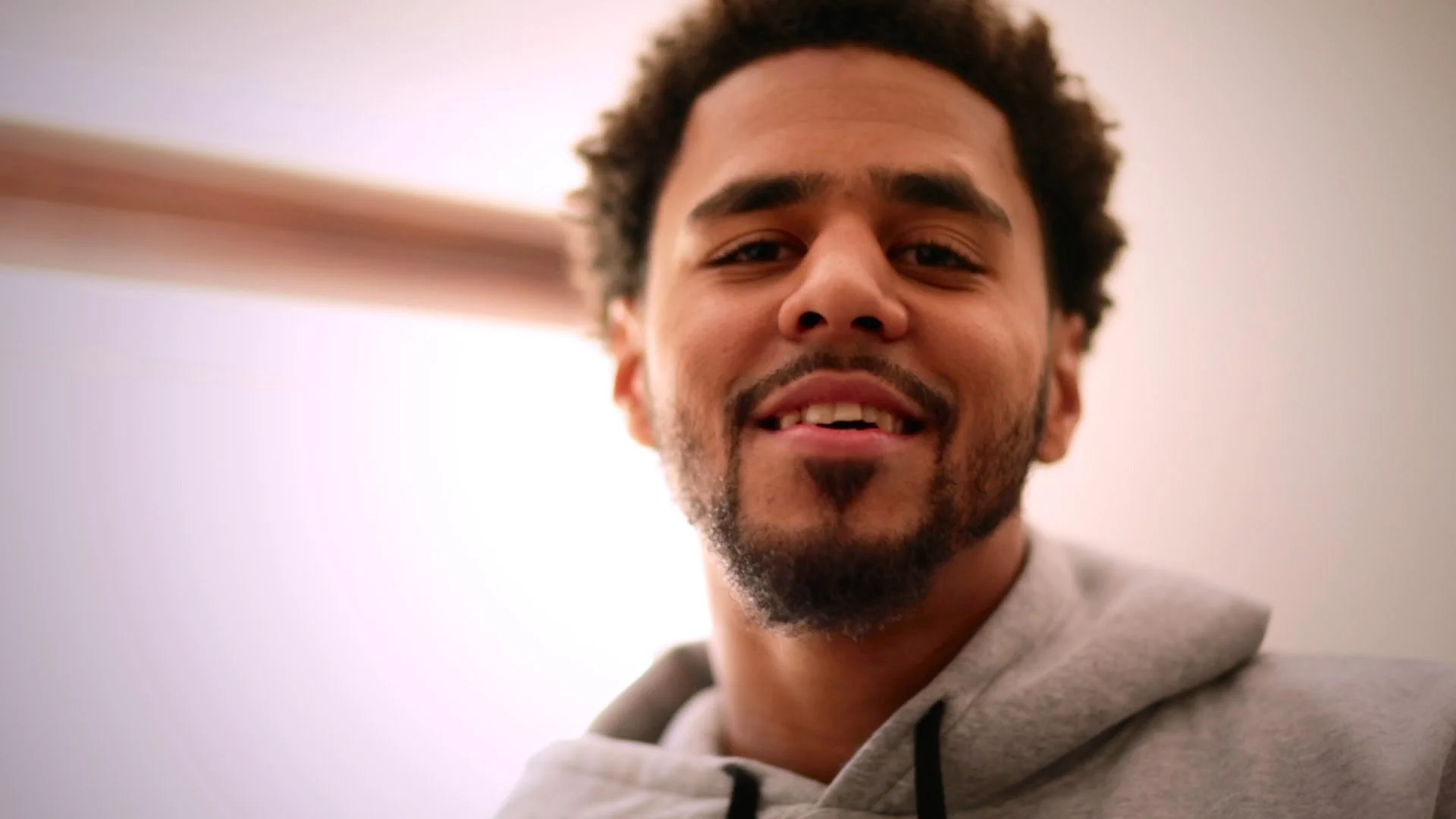 J. Cole looking really hot in a heathered grey sweatshirt.jpg