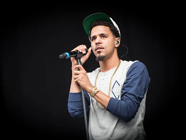 J. Cole looking hot in a nice shirt as he holds the microphone.jpg