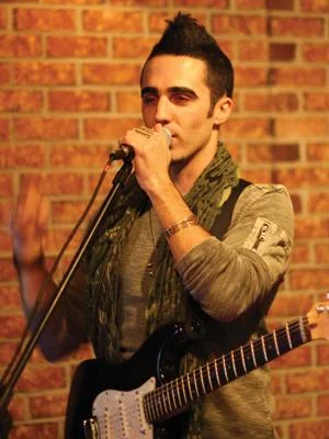 Dru Decaro singing into the microphone.jpg