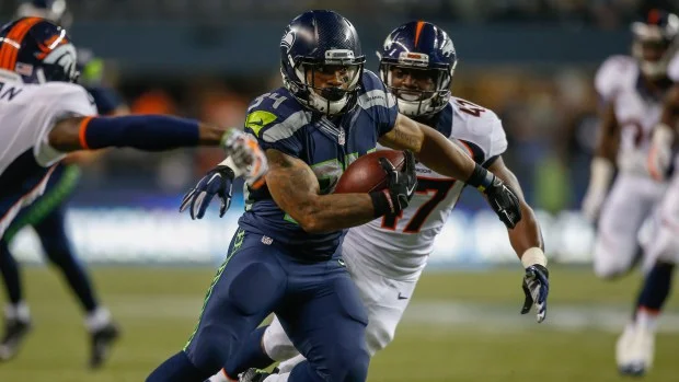 Thomas Rawls running with the ball looking hot during the Broncos game.jpg