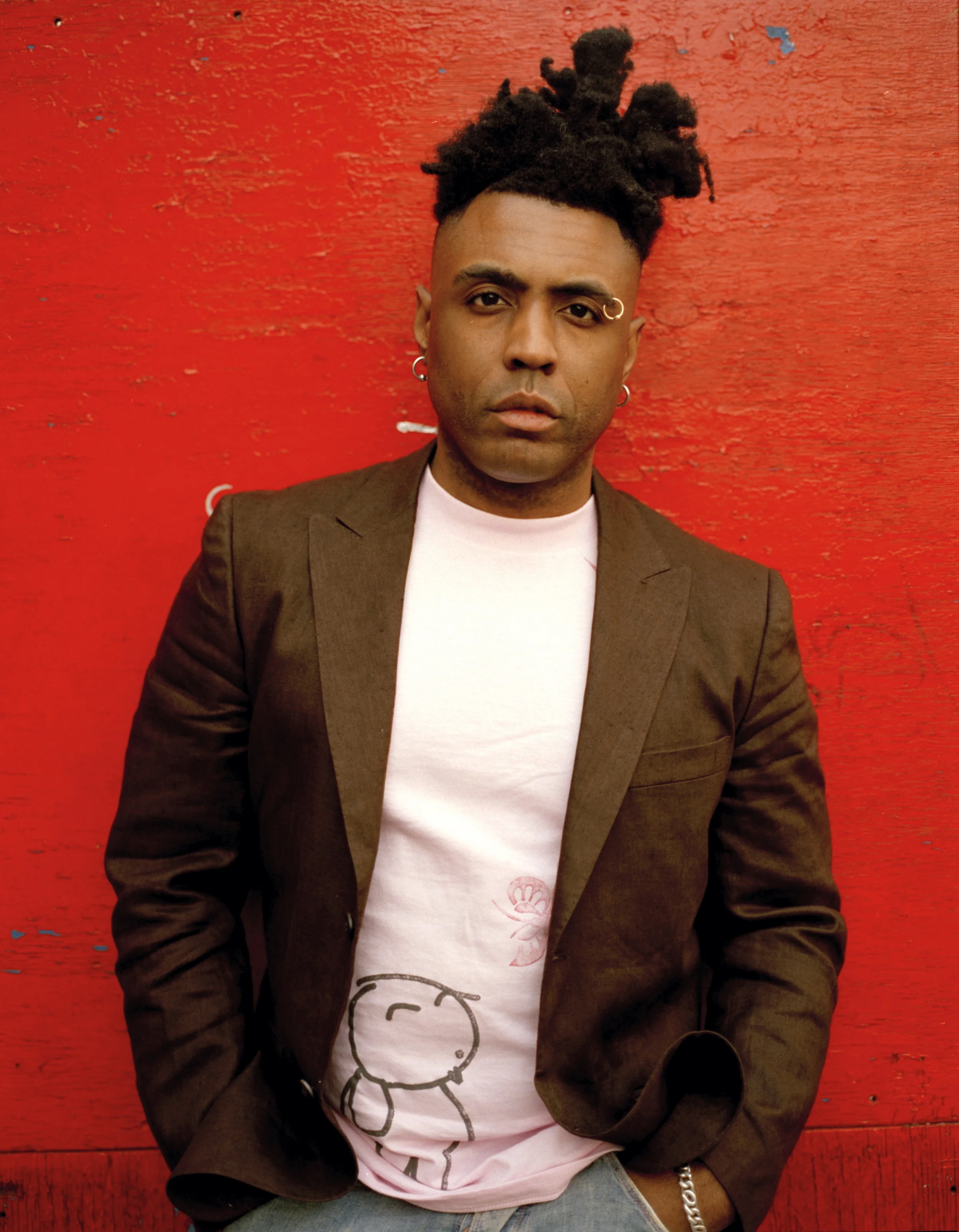 Omar looking hot behind a poorly painted red wall.jpg