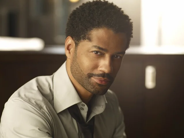 Eric Benét looking hot af in a dark linen dress shirt with the collar loosely opened.jpg