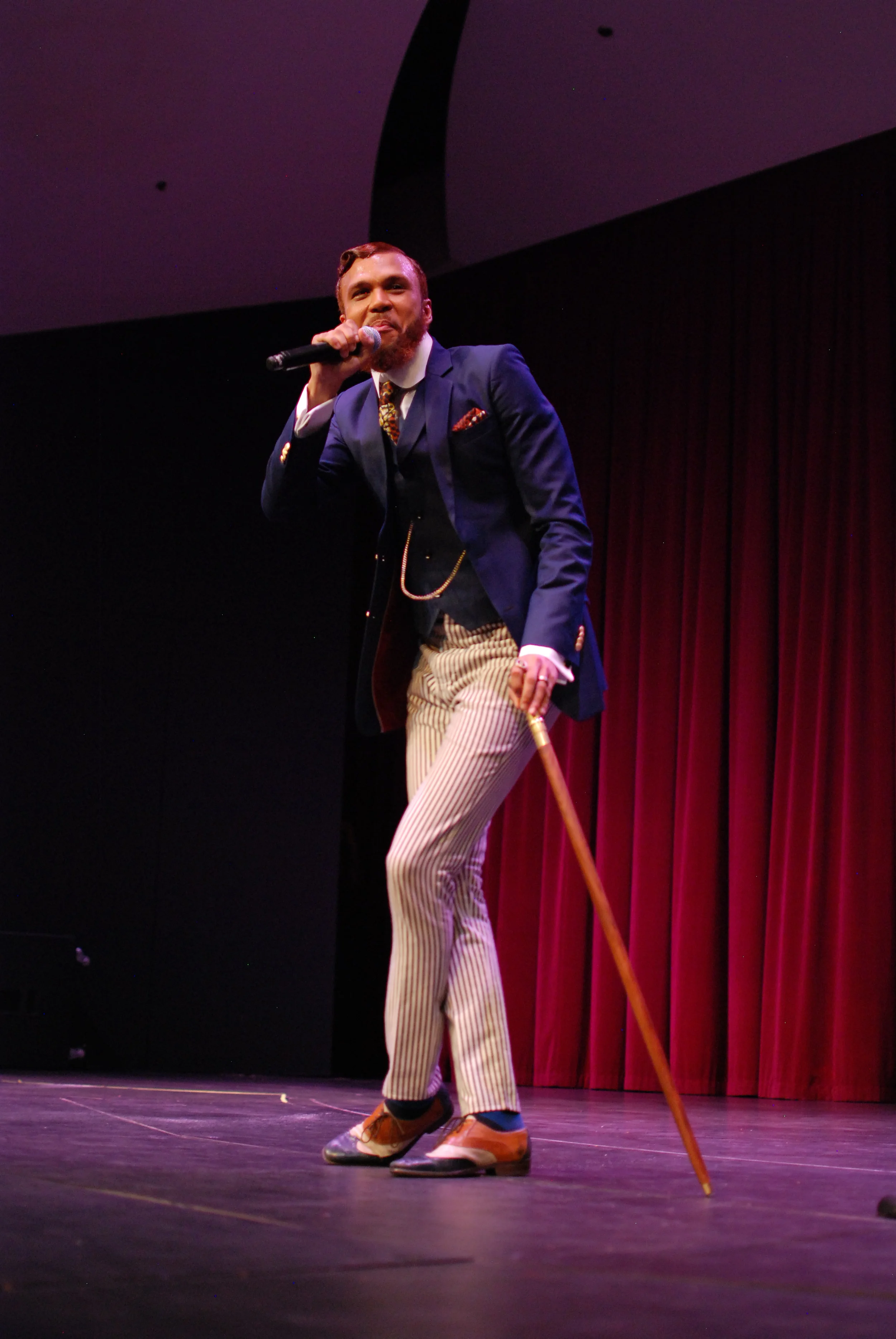 Jidenna crouching down on stage to deter people from knowing that he's Slender Man.jpg