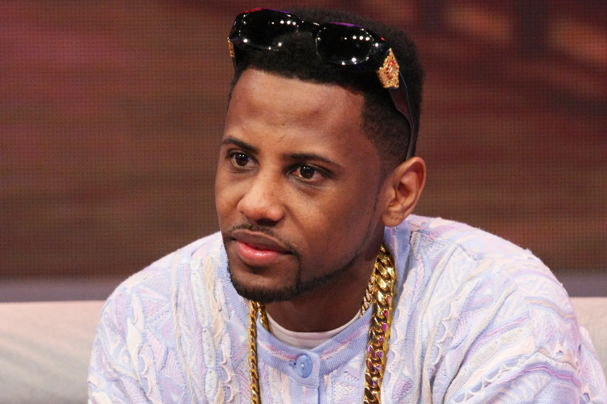 Fabolous looking gorgeous in a pastel shirt with his sunglasses on top of his head.jpg